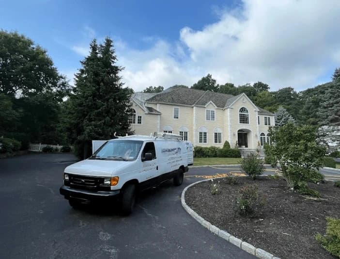 Lorain Power Washing technician performing thorough gutter cleaning service in Lorain